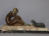 statue of a woman and a dog sitting on a marble base