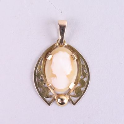 an image of a gold pendant with a white stone in the center