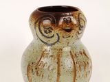 a small vase that has a brown and white design on it