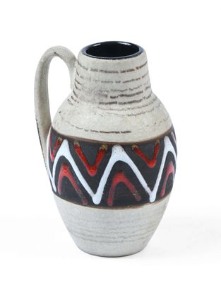 a white vase with a black and red design on it