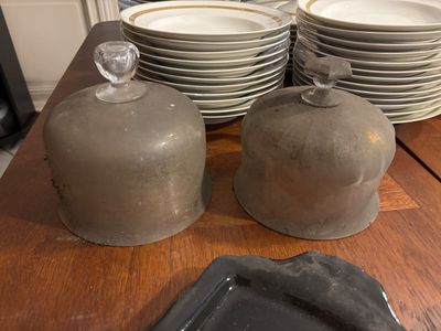 many plates and bowls sitting on a wooden table