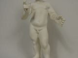 a white statue of a boy holding something in his hand
