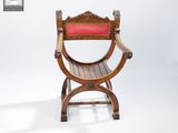 a wooden chair with a red cushion on top of it