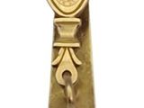 a gold tie bar with a skull and crossbone on it