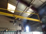 a large yellow crane hanging from the ceiling of a building