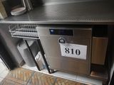 une photo d'un plan de travail en acier inoxydable sur lequel est posée une plaque d'immatriculation