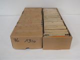 two boxes of old records are sitting on a white surface
