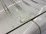 a close up of a dirty car with a ruler on the hood