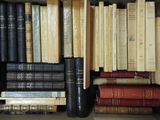 many books that are stacked in a box together