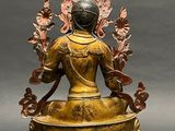 bronze statue of a seated person with a crown on her head