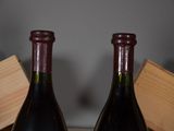 two bottles of wine sitting next to each other on a table