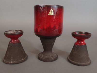 three red candles sitting next to each other on a table