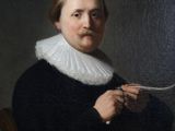 portrait of a man in a black coat with a white ruffled collar