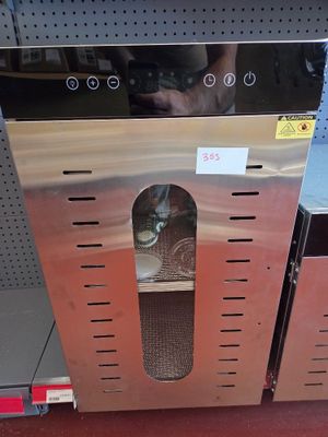 a cat that is sitting inside of a stainless steel oven