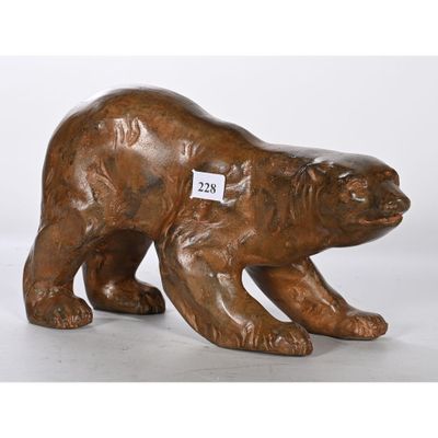 sculpture en bronze représentant un ours portant une étiquette sur la poitrine