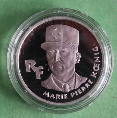silver coin with a portrait of a man in a top hat