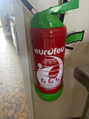 a red fire extinguisor attached to a wall