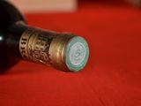 a bottle of wine sitting on a red cloth