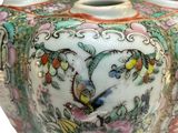 a picture of a vase with a bird and flowers on it