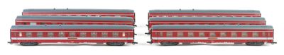 two red and gray train cars sitting side by side