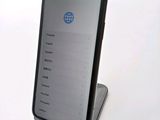 a phone that is sitting on a stand on a table