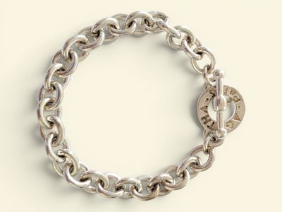 a close up of a silver bracelet with a lock on it