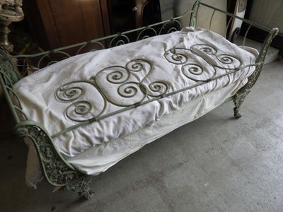 a bed with a white sheet on it in a room