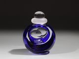 une bouteille en verre bleue munie d'un bouchon blanc