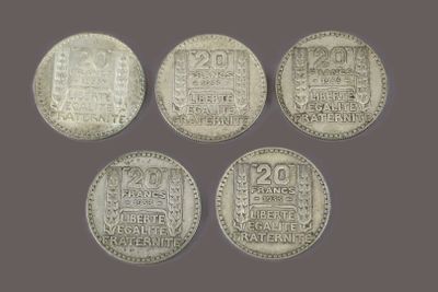 four silver coins with chinese writing on them on a gray background