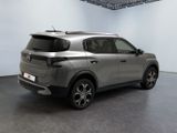 the rear view of a silver suv parked in a garage