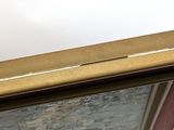 a picture of a gold frame with a picture on it