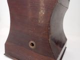 a wooden box with a hole in it on a white surface