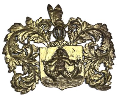 a close up of a gold plate with a coat of arms on it