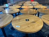 many wooden tables and stools in a room