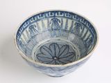 a blue and white bowl with designs on it