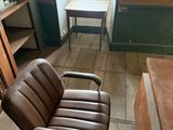 a chair that is sitting in a room with a book shelf