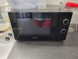 a microwave that is sitting on a counter in a kitchen