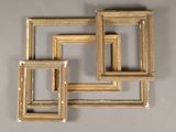 three gold picture frames on a wall with a white background