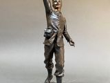 bronze statue of a man holding a bird in his hand