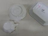 two cups and a saucer sitting on a table