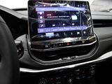 the interior of a car with a touch screen and steering wheel