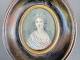 painting of a woman in a tiable on a plate with a gold rim