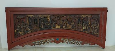 a wooden panel with carvings on it in a room