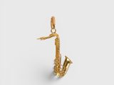 a close up of a gold saxophone pendant on a white background