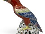 an image of a figurine of a parrot on a rock