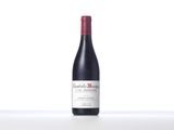 the bottle of red wine is sitting on the table