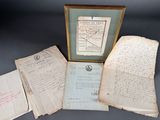 some old papers are sitting on a table next to a framed picture