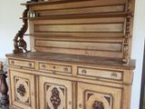 a wooden cabinet with carvings on it in a room