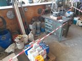 a picture of a garage with a lot of clutter on the floor