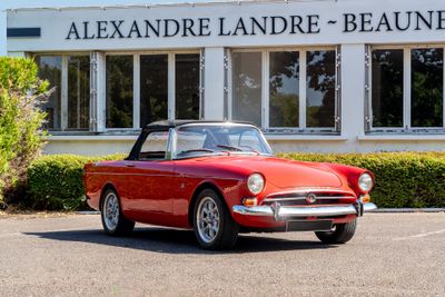 a red convertible car parked in front of a building